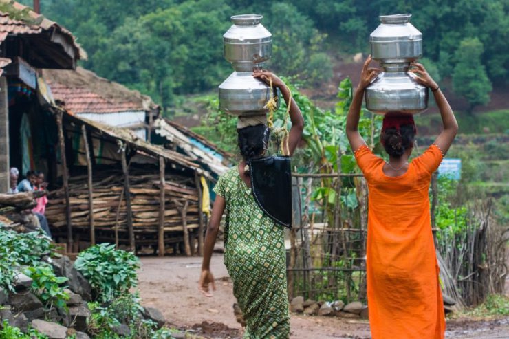 Women carrying containers of water above their heads